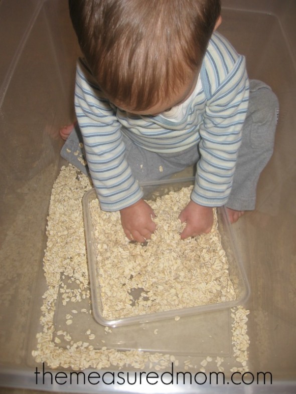 child squeezing oats