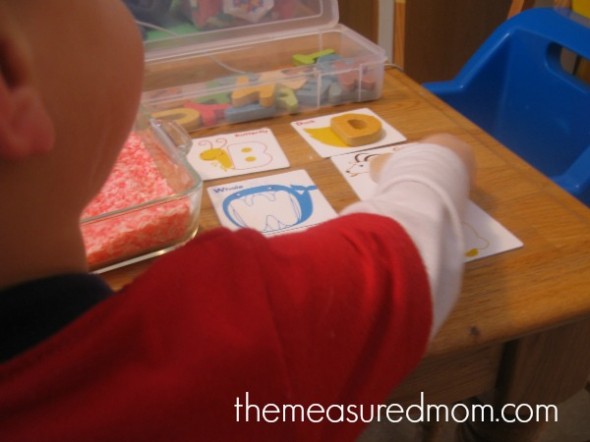 child with letters and letter cards