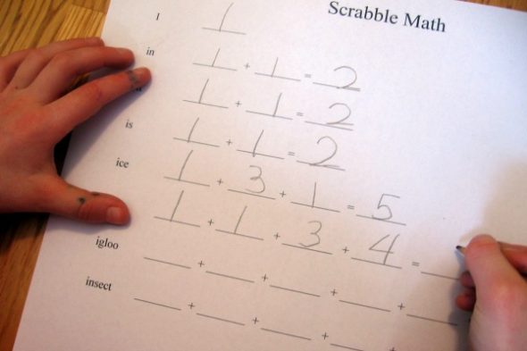 child writing on worksheet