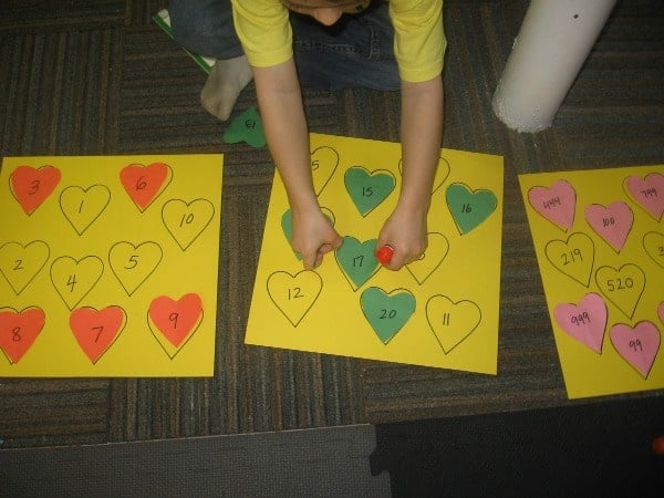child placing heart on paper