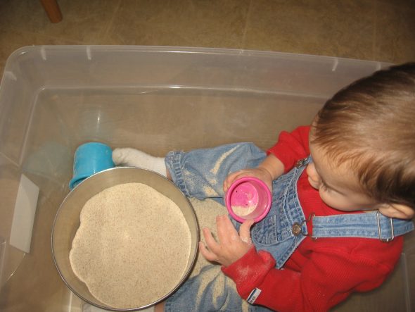 baby playing in "sandbox"