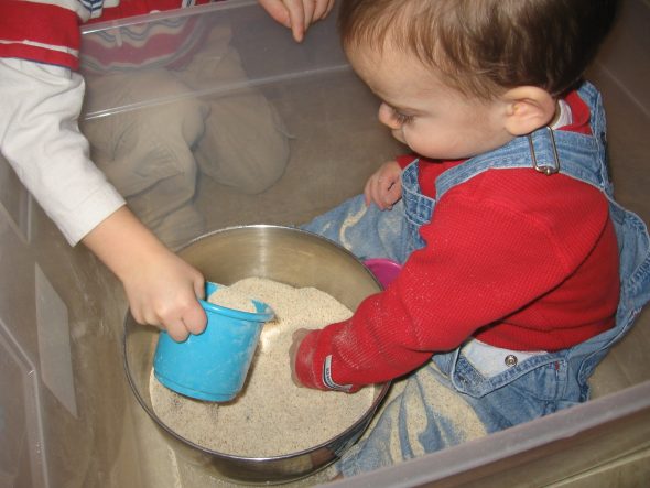 baby playing in "sandbox"