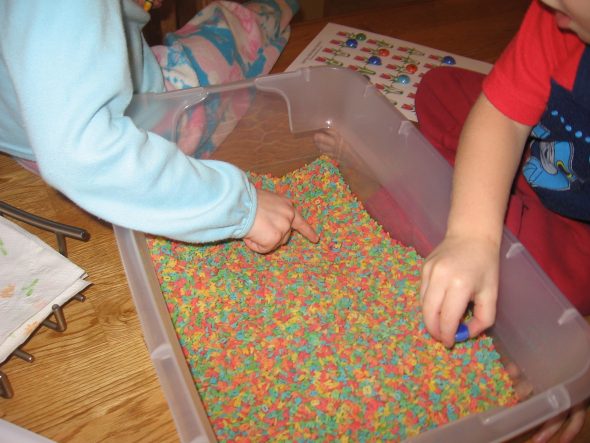 children with alphabet sensory bin