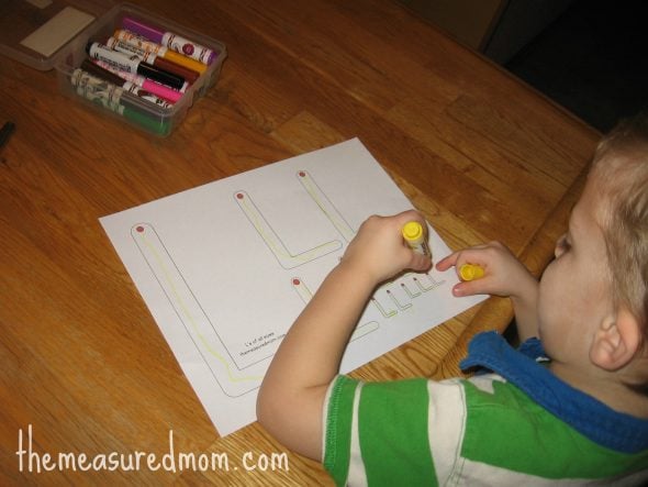 child forming L's on letter L worksheet