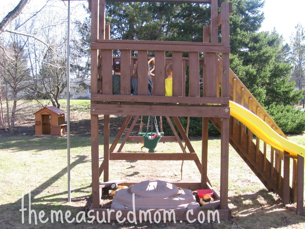 children sitting on playset