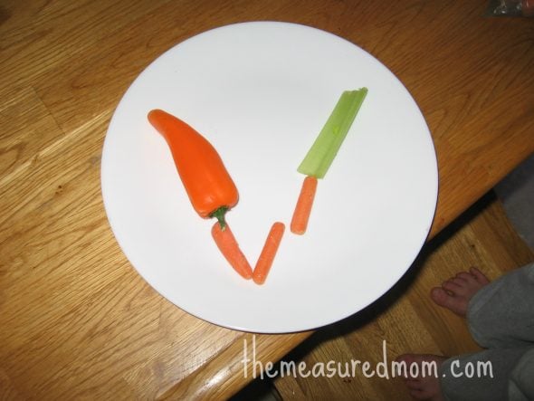 child with V made out of vegetables