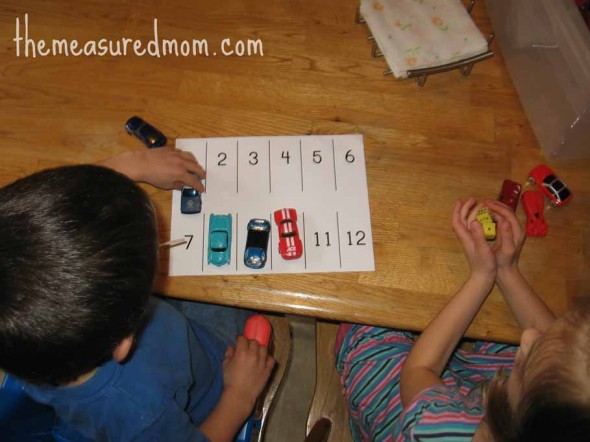 children rolling dice and parking cars