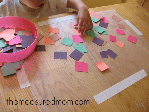 child doing contact paper craft