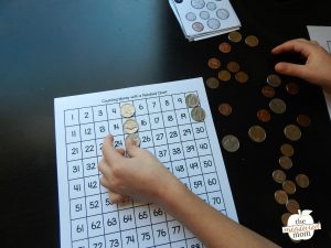 Counting money with a hundred chart - The Measured Mom